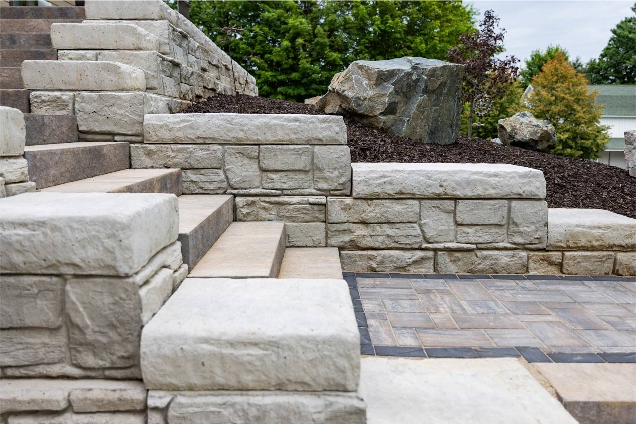 Side-view of a staircase integrated into a retaining wall made with precast modular block.